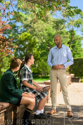 January 2024 / Teacher-Standing-with-2-Studenst-Sitting-Outdoors_240122_Z9E8514