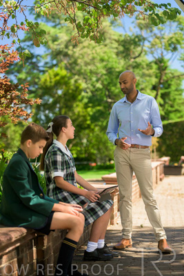 January 2024 / Teacher-Standing-with-2-Studenst-Sitting-Outdoors_240122_Z9E8534