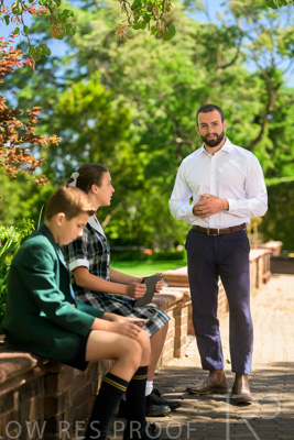 January 2024 / Teacher-Standing-with-2-Studenst-Sitting-Outdoors_240122_Z9E8619