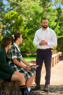 January 2024 / Teacher-Standing-with-2-Studenst-Sitting-Outdoors_240122_Z9E8625