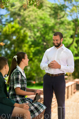 January 2024 / Teacher-Standing-with-2-Studenst-Sitting-Outdoors_240122_Z9E8666
