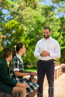 January 2024 / Teacher-Standing-with-2-Studenst-Sitting-Outdoors_240122_Z9E8670