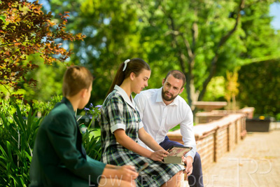 January 2024 / Teacher-with-2-Student-Sitting-Outdoors_240122_Z9E7875