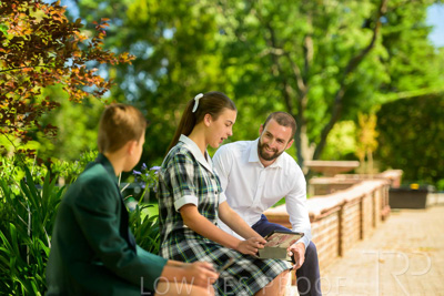 January 2024 / Teacher-with-2-Student-Sitting-Outdoors_240122_Z9E7880