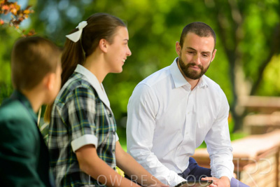 January 2024 / Teacher-with-2-Student-Sitting-Outdoors_240122_Z9E8025