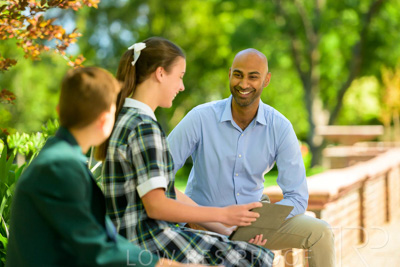 January 2024 / Teacher-with-2-Student-Sitting-Outdoors_240122_Z9E8575